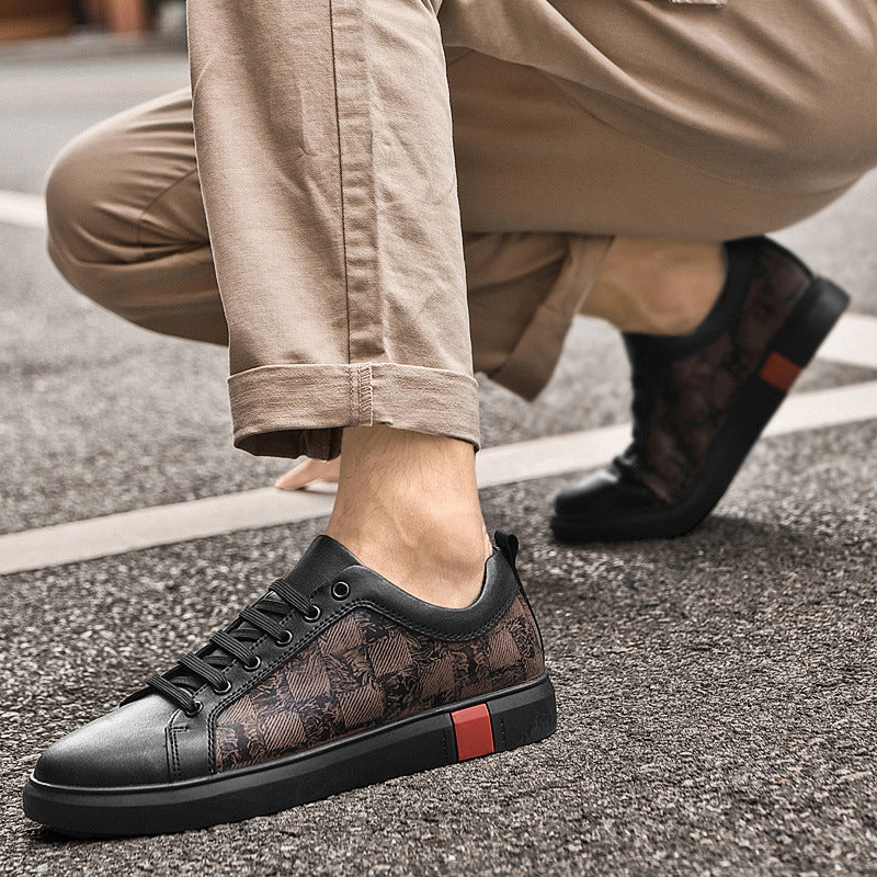 Black and brown patterned sneaker worn by a person on a street.