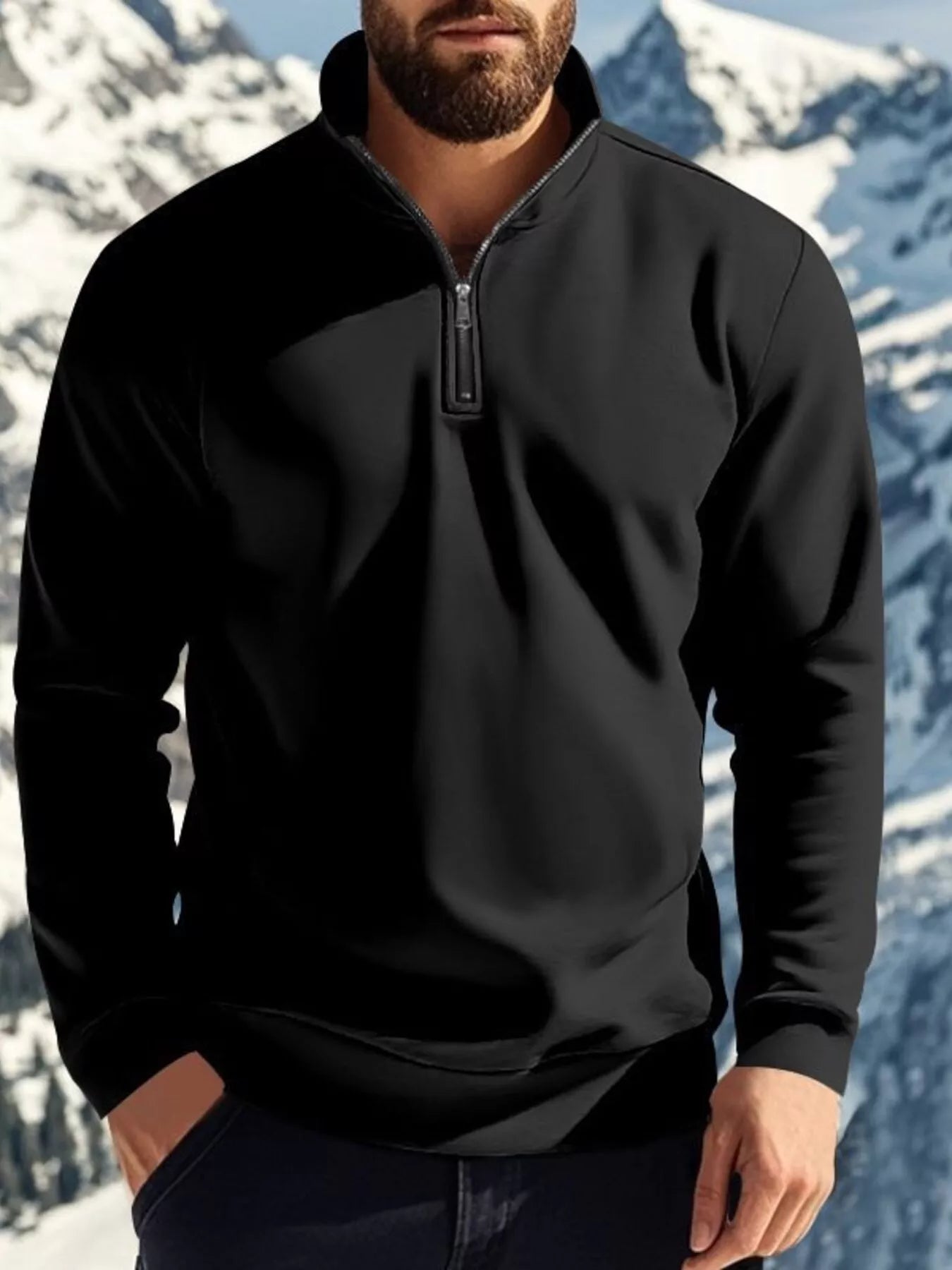 Person wearing a black quarter-zip sweatshirt with a mountainous background