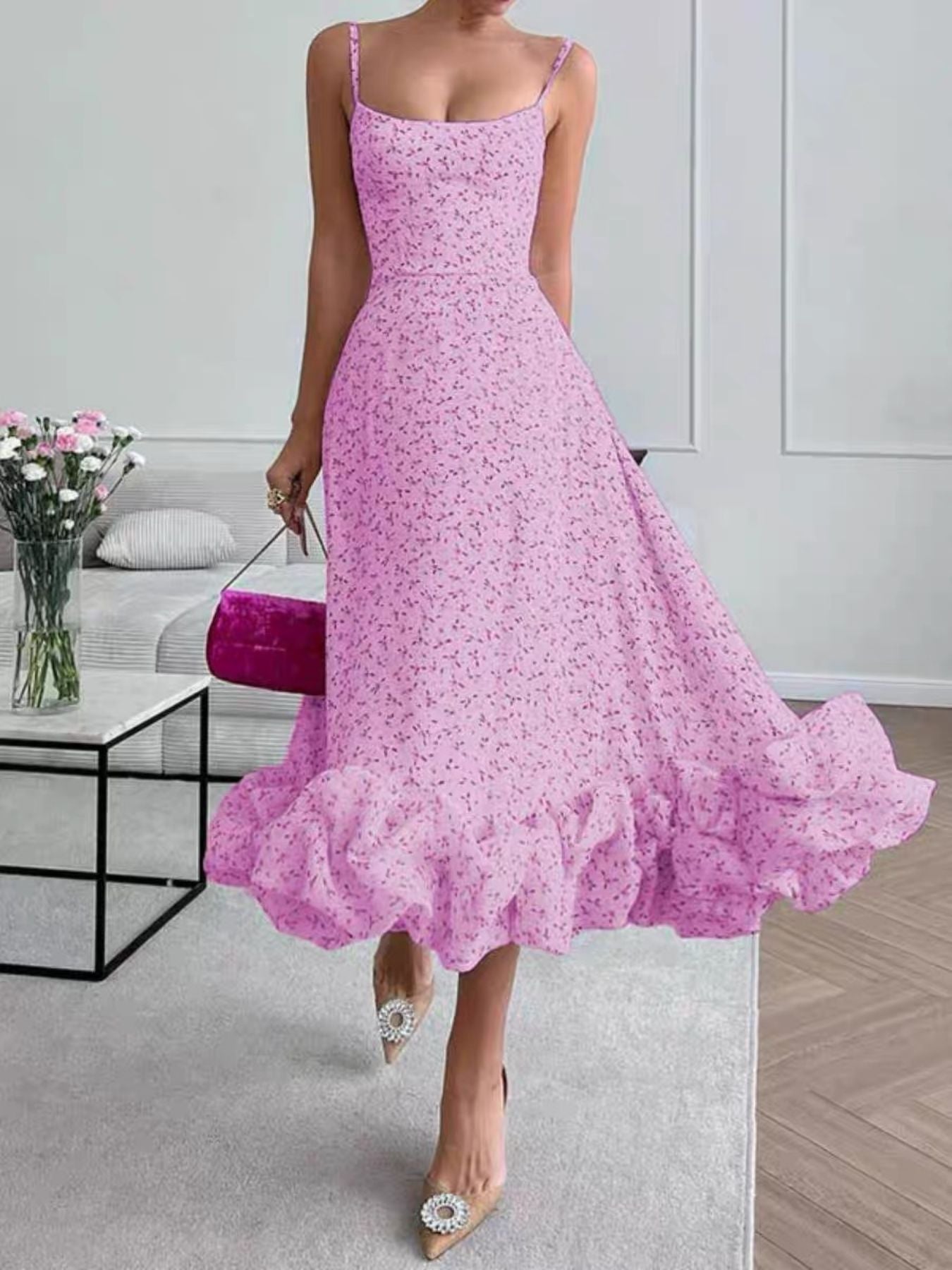 Woman wearing a pink floral dress in an indoor setting