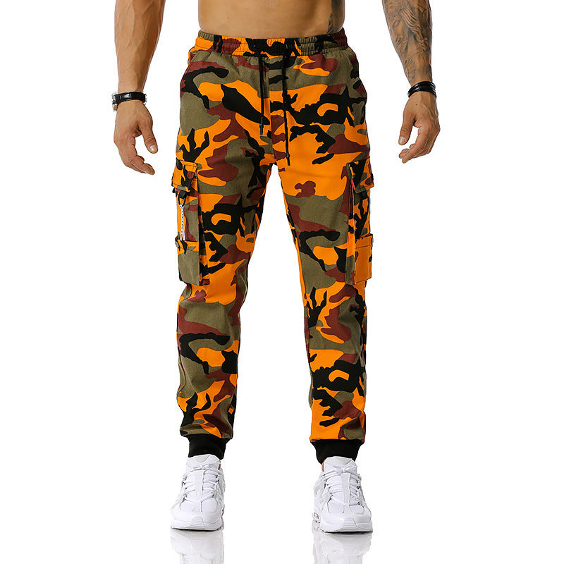Camouflage pants worn by a person on a white background