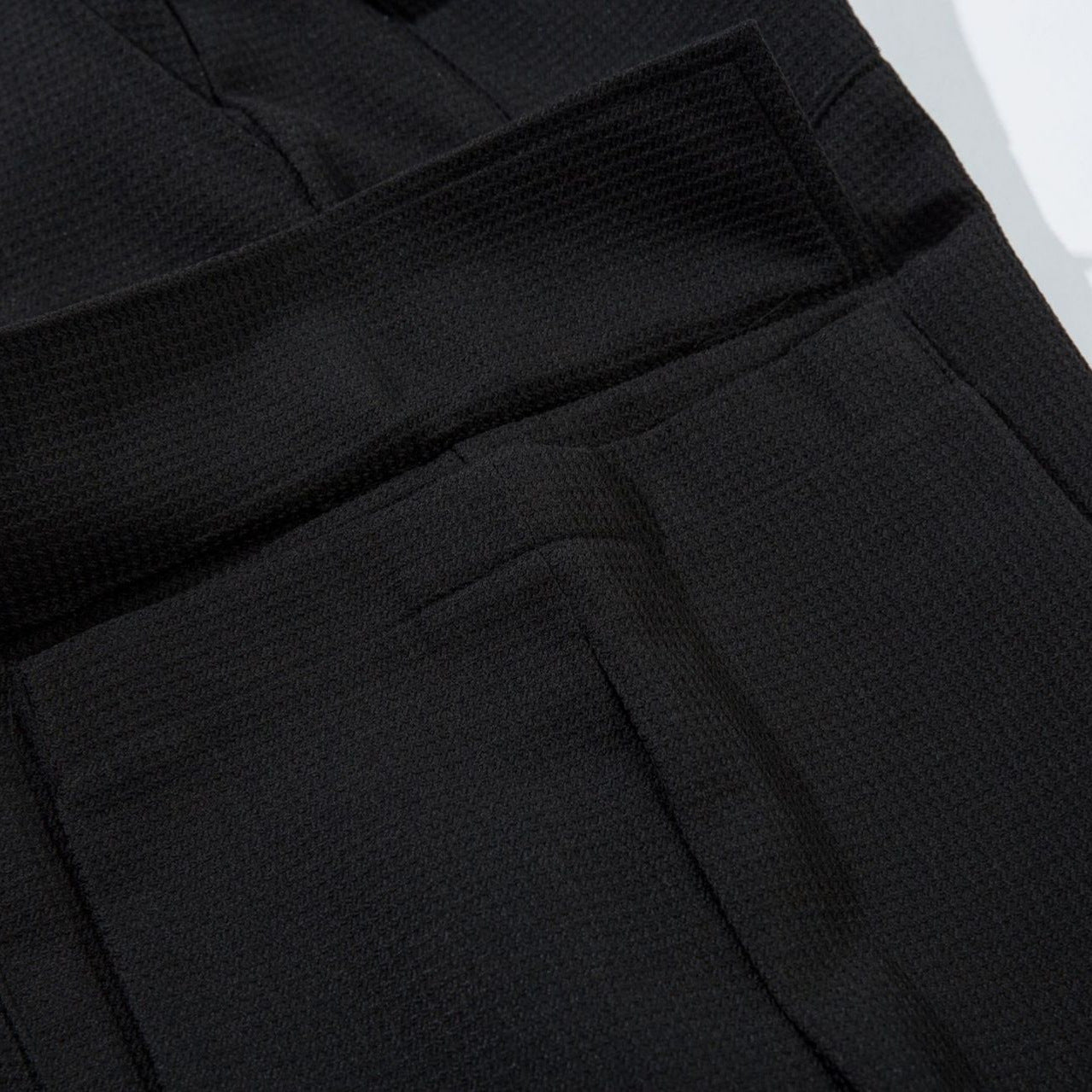 Close-up of black pants with a textured pattern