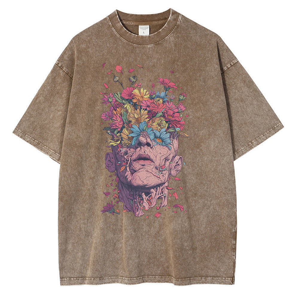 Brown t-shirt with a colorful graphic of a face with flowers on a white background