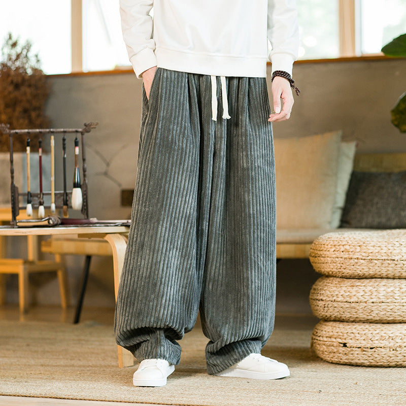Person wearing gray corduroy pants in a living room setting
