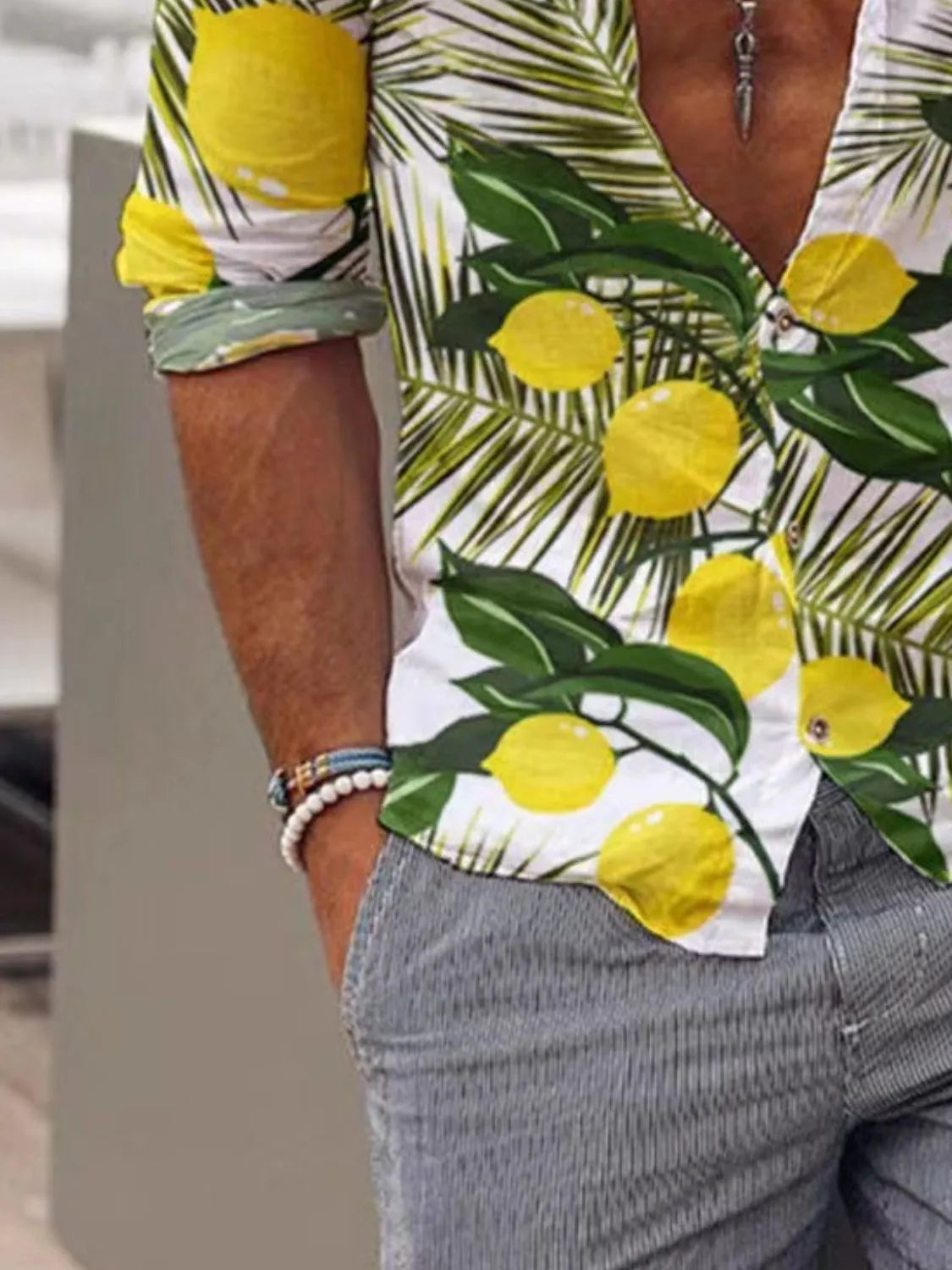 Person wearing a shirt with lemon and palm leaf pattern