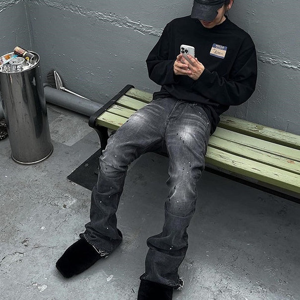 Person sitting on a bench using a phone in an urban setting