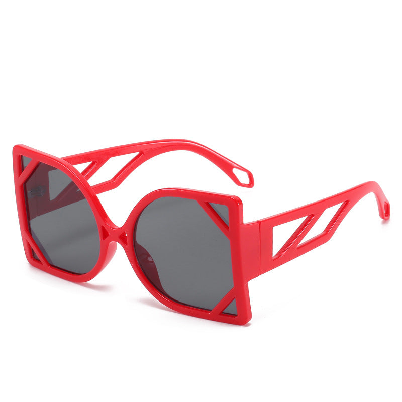Red sunglasses with a geometric frame on a white background