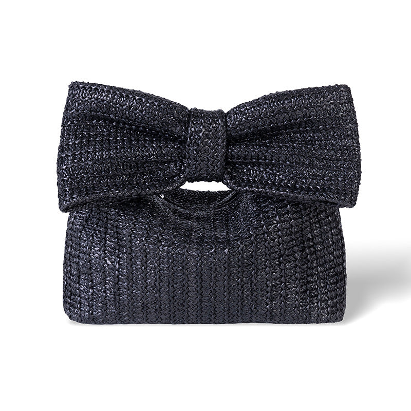 Black textured clutch bag with a bow on a white background
