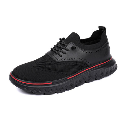 Black athletic shoe with red accent on a white background