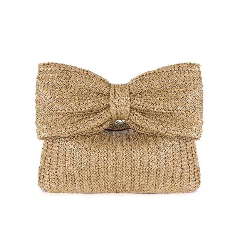 Gold glittery clutch bag with a bow on a white background
