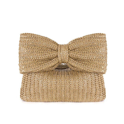 Gold glittery clutch bag with a bow on a white background