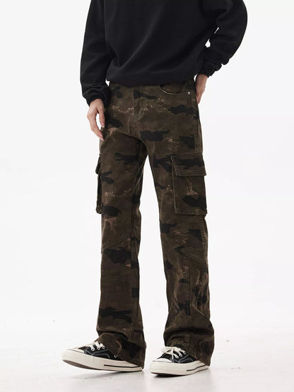 Person wearing camouflage cargo pants and a black sweater on a white background