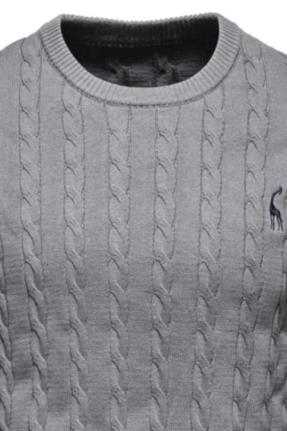 Gray cable knit sweater with a small logo on the chest pocket.