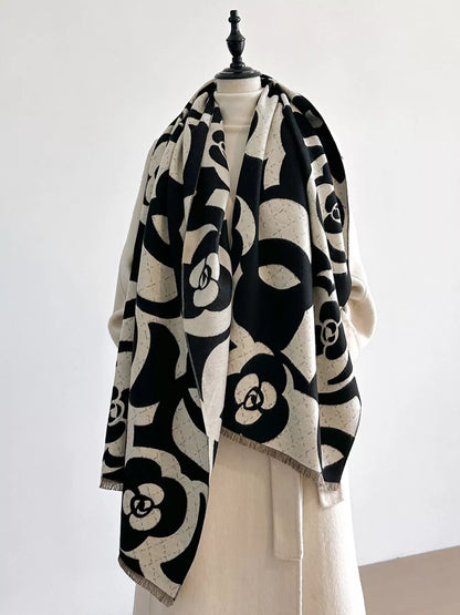 Black and white patterned scarf on a mannequin against a white background