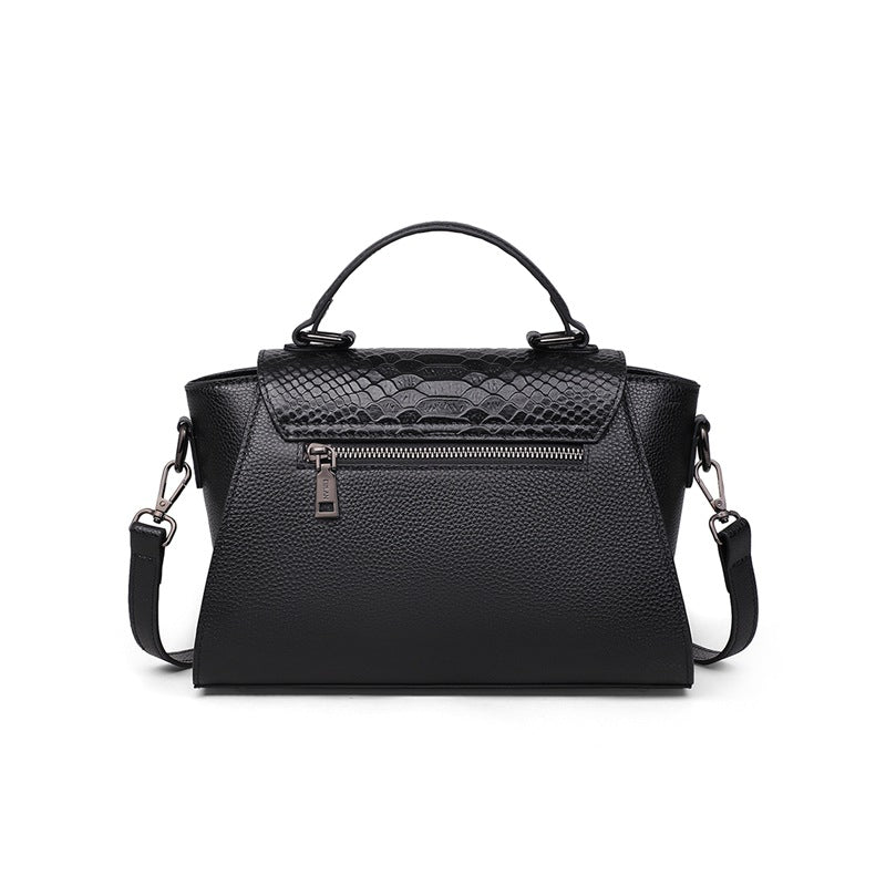 Black handbag with textured pattern on a white background