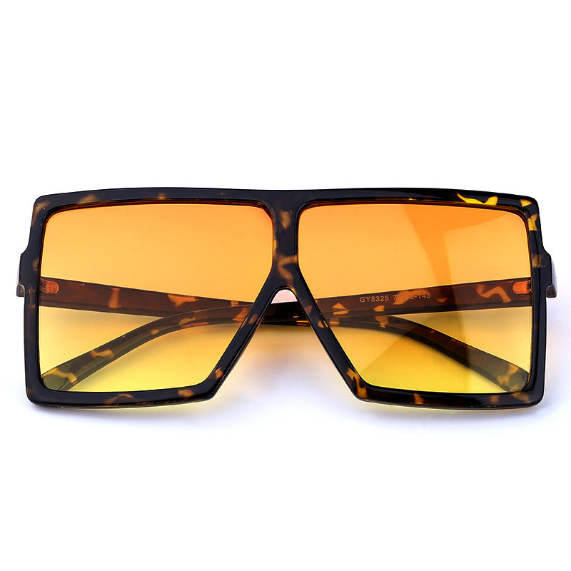 Sunglasses with tortoiseshell frame and yellow lenses on a white background