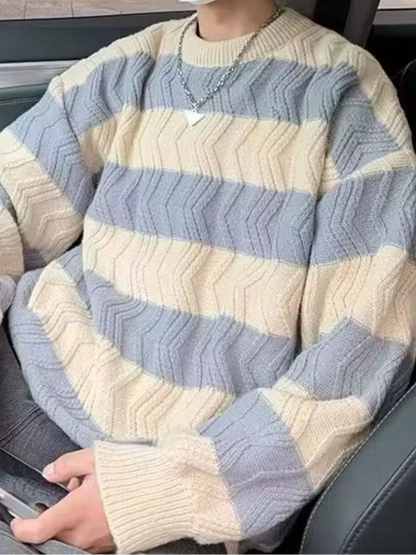 Person wearing a striped sweater sitting inside a vehicle.