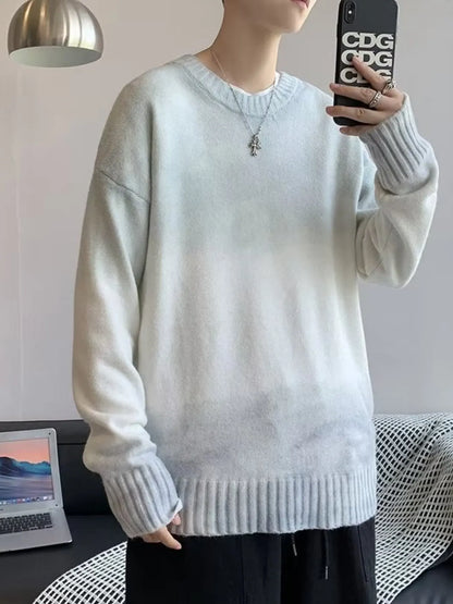 Person wearing a light gray sweater taking a mirror selfie.