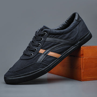 Black sneaker with a brown accent on a gray background