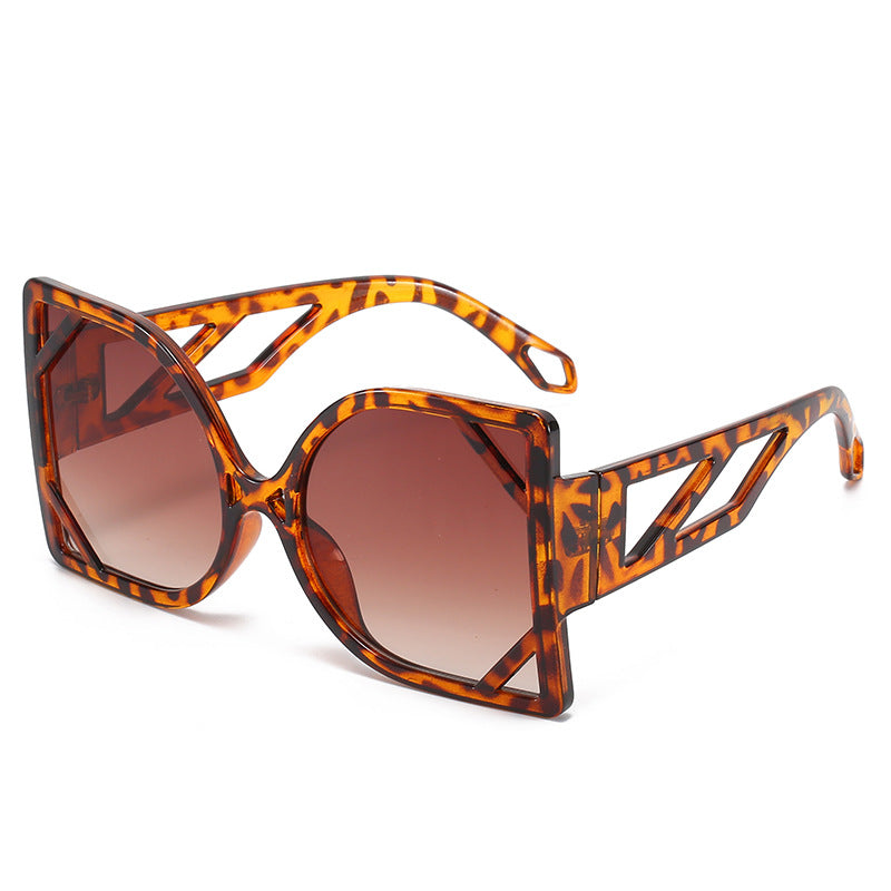 Sunglasses with tortoiseshell frame and brown gradient lenses on a white background