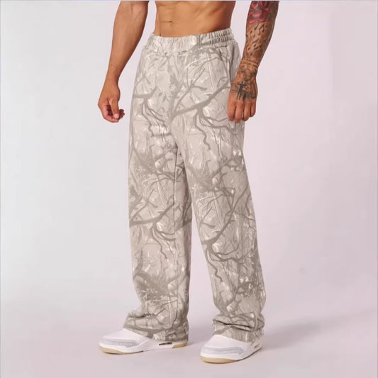 Person wearing light-colored camouflage pants on a white background
