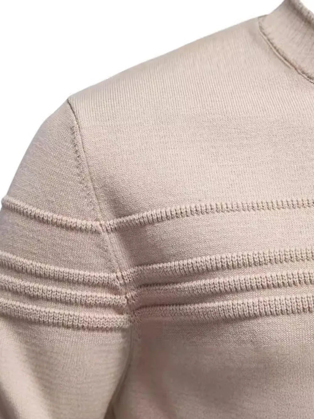 Close-up of a beige sweater with ribbed texture