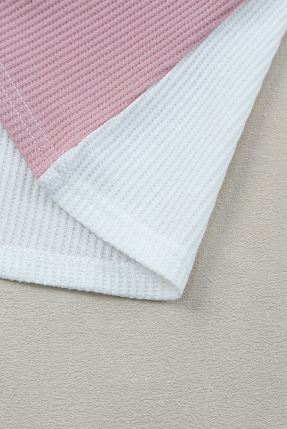 Close-up of a pink and white textured fabric on a beige surface