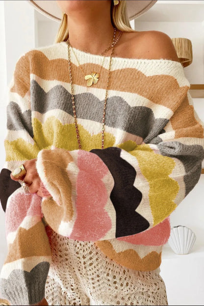 Person wearing a colorful, patterned sweater with a blurred background