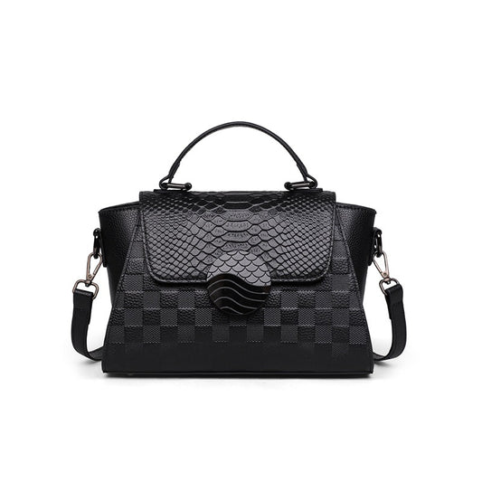 Black handbag with snake skin pattern on a white background