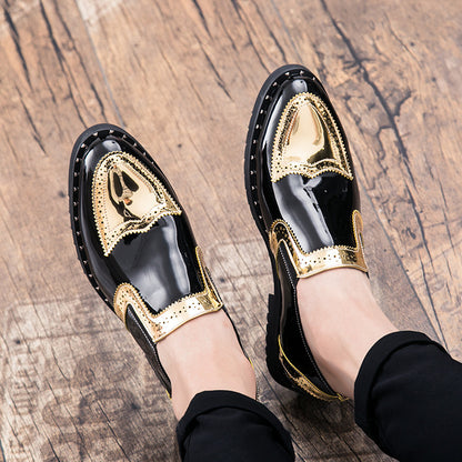Black shoes with gold accents worn on a wooden floor