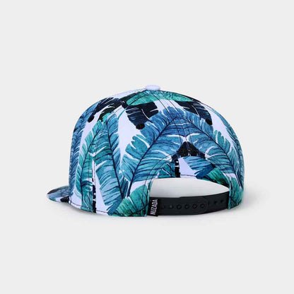 Cap with tropical leaf pattern on a light gray background
