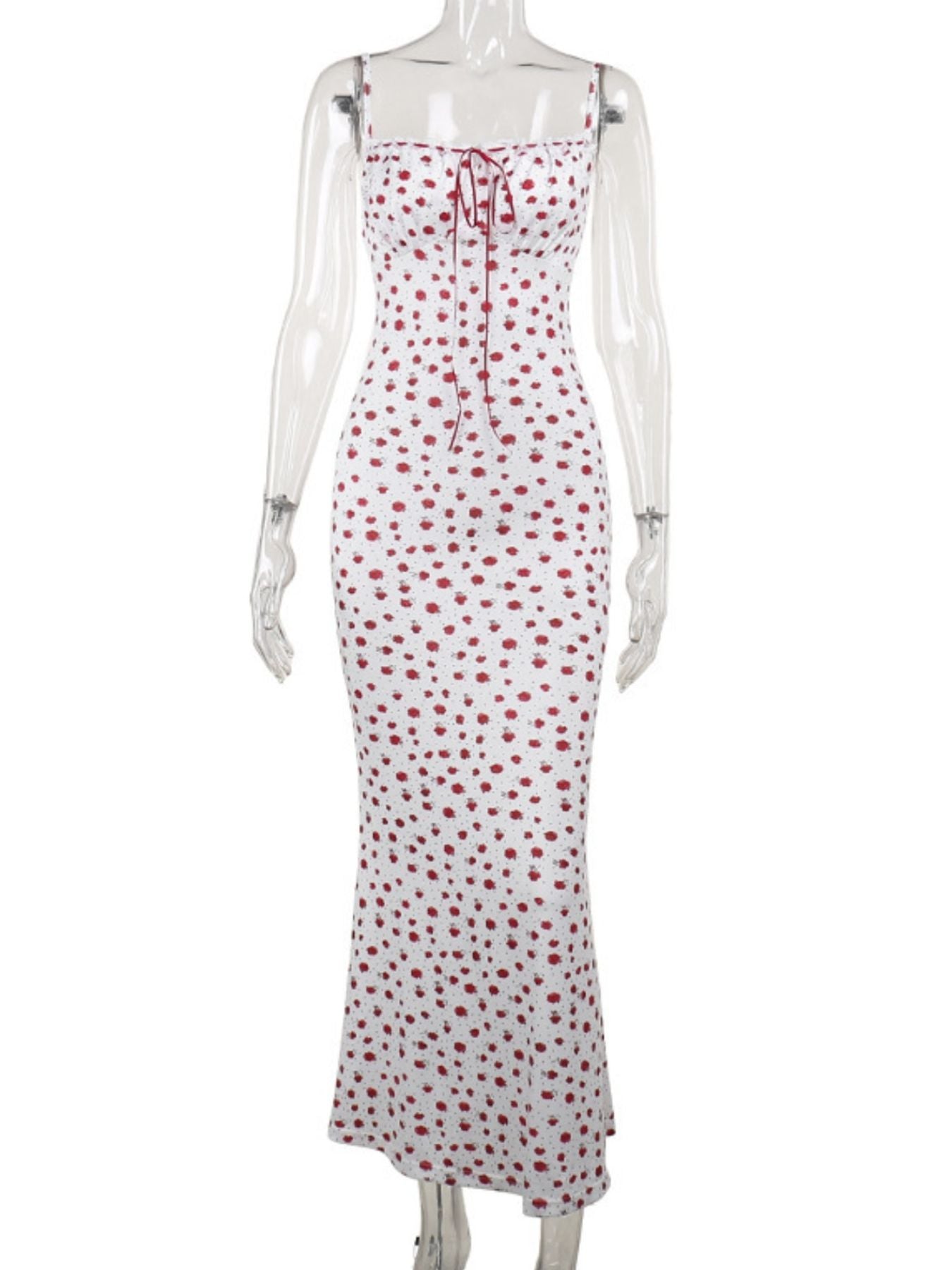 White dress with red polka dot pattern on a mannequin against a white background