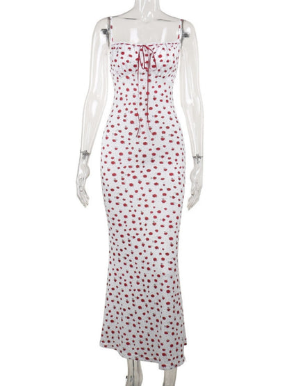White dress with red polka dot pattern on a mannequin against a white background