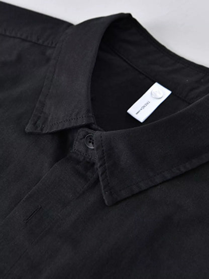 Black shirt with a visible brand label on a light gray background