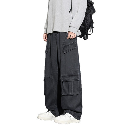 Person wearing black cargo pants with a white background