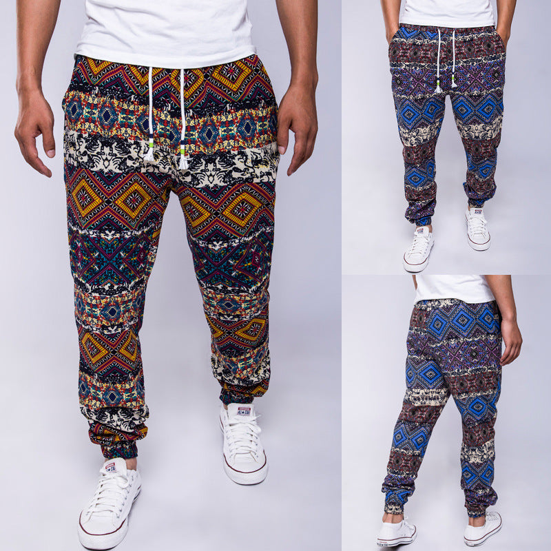 Multicolored patterned pants worn by a person on a white background