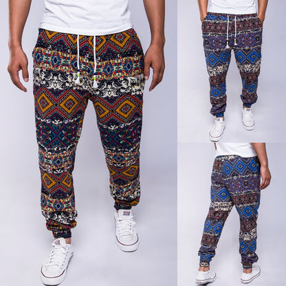 Multicolored patterned pants worn by a person on a white background