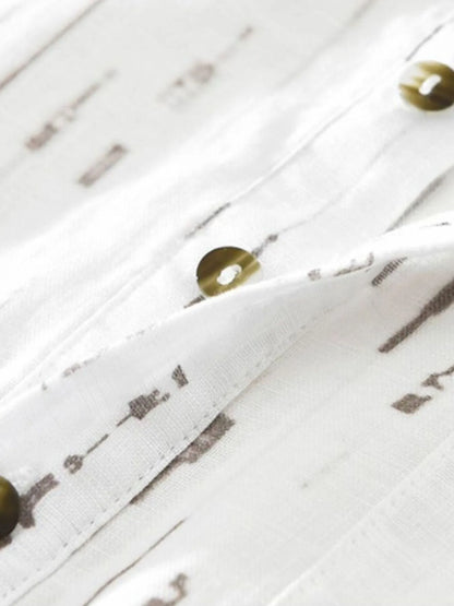 Close-up of a white wooden surface with decorative elements and small round objects.