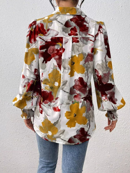 Person wearing a colorful floral jacket against a plain background