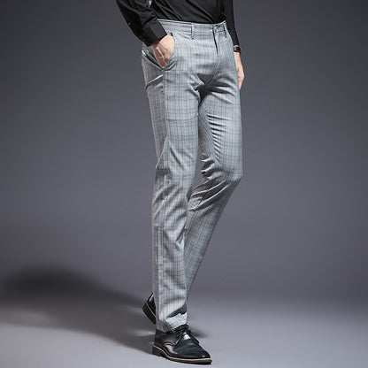 Gray checkered pants worn by a person on a gray background
