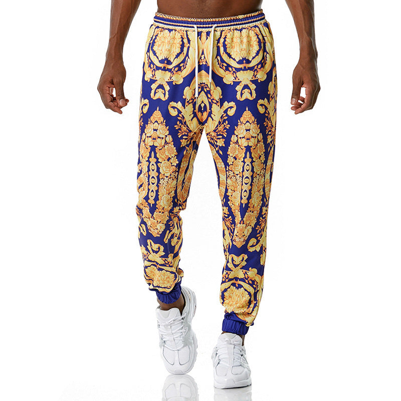Blue and gold patterned jogger pants worn by a person on a white background