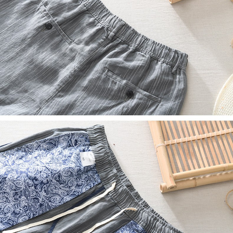 Gray shorts with an elastic waistband on a light surface.