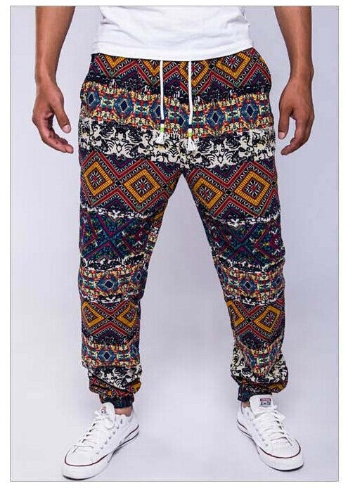 Multicolored patterned pants worn by a person on a white background