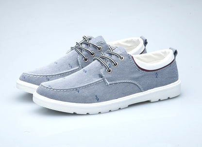 Pair of gray casual shoes with white soles on a light gray background