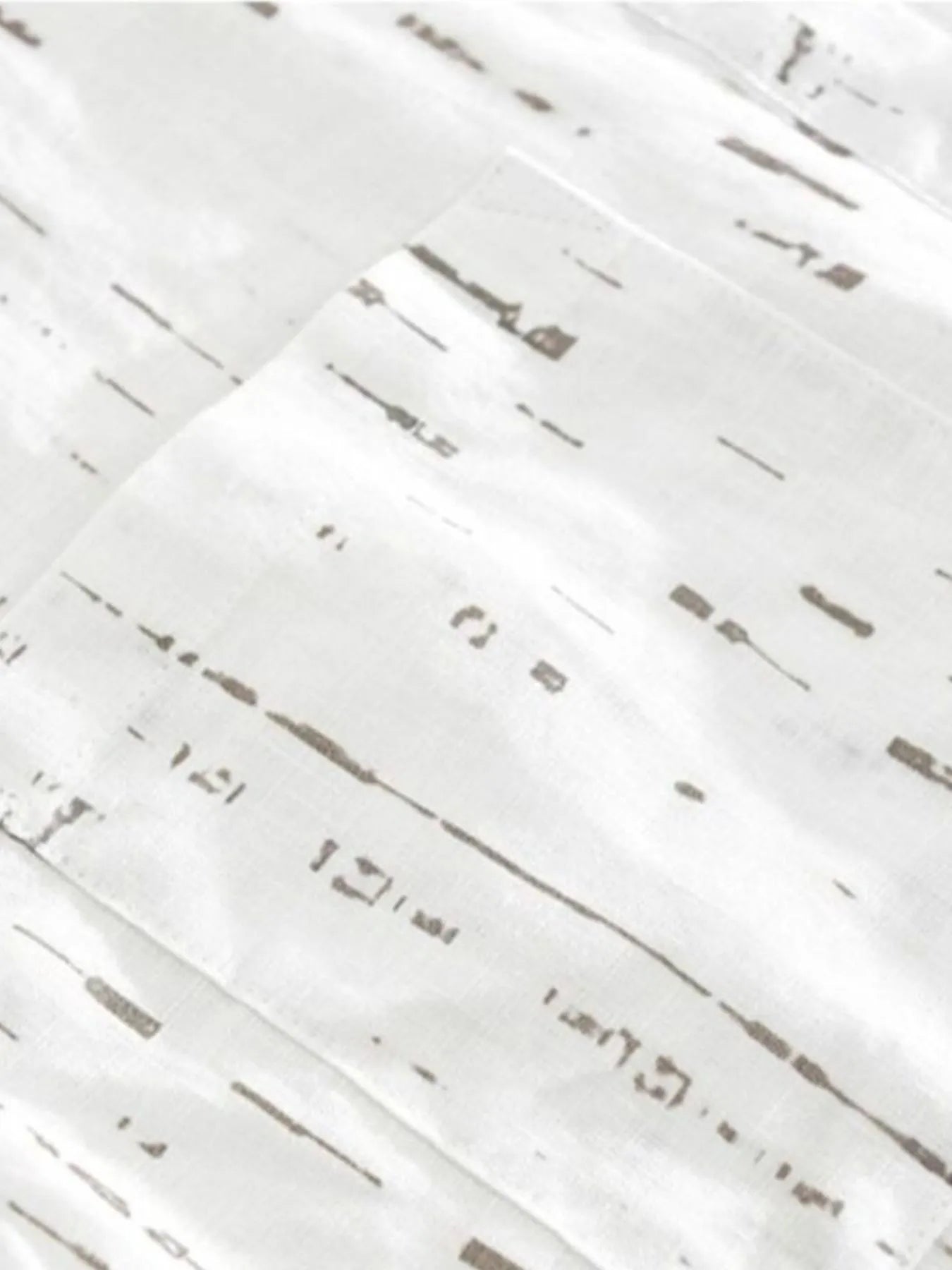 Close-up of white fabric with subtle pattern