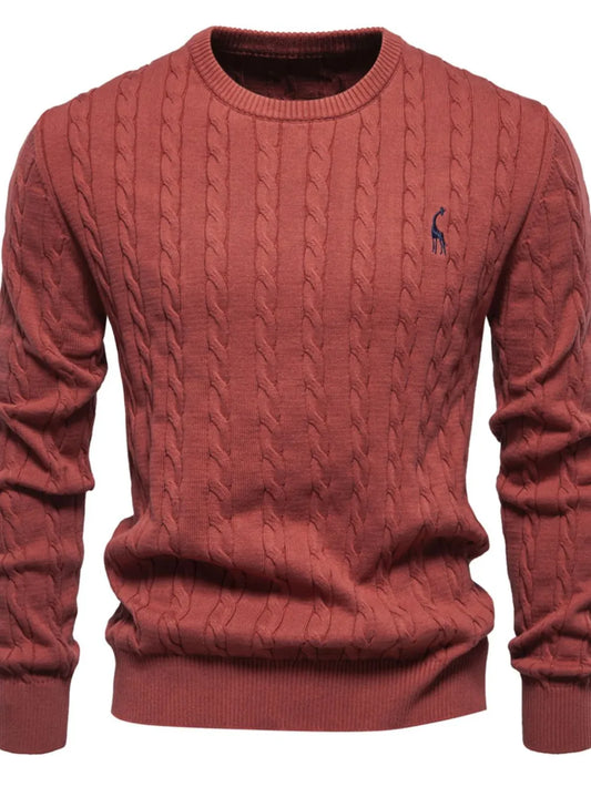 Red cable knit sweater with a small logo on a white background