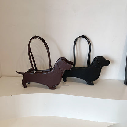 Two dachshund-shaped handbags in brown and black on a white background