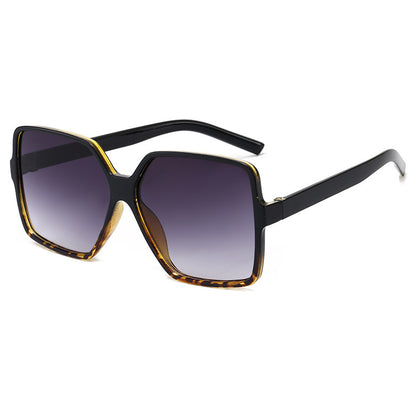 Sunglasses with black frame and gradient lenses on a white background