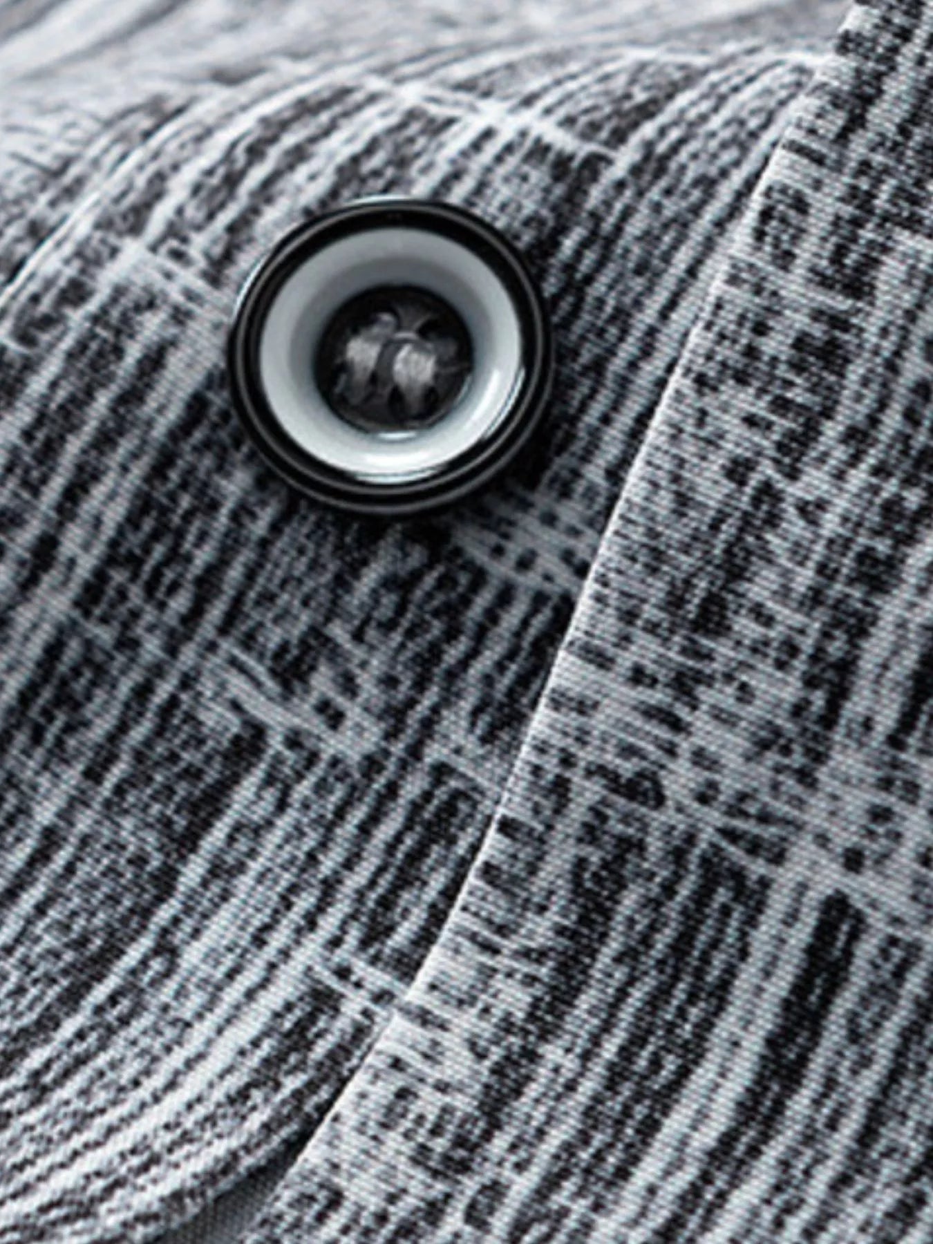 Close-up of a button on a textured fabric surface