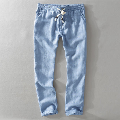 Light blue pants with drawstring on a gray background