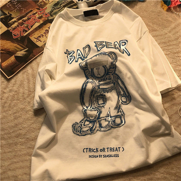 White long-sleeve shirt with 'Bad Bear' graphic design on a textured surface.